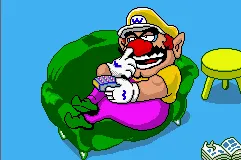 Wario lying on his couch and pickin' at it.