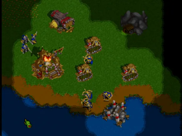 WarCraft II: The Dark Saga PlayStation Humans rading an orc town.
